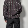 Donkere gebreide sweater met grafisch patroon en paarse accenten