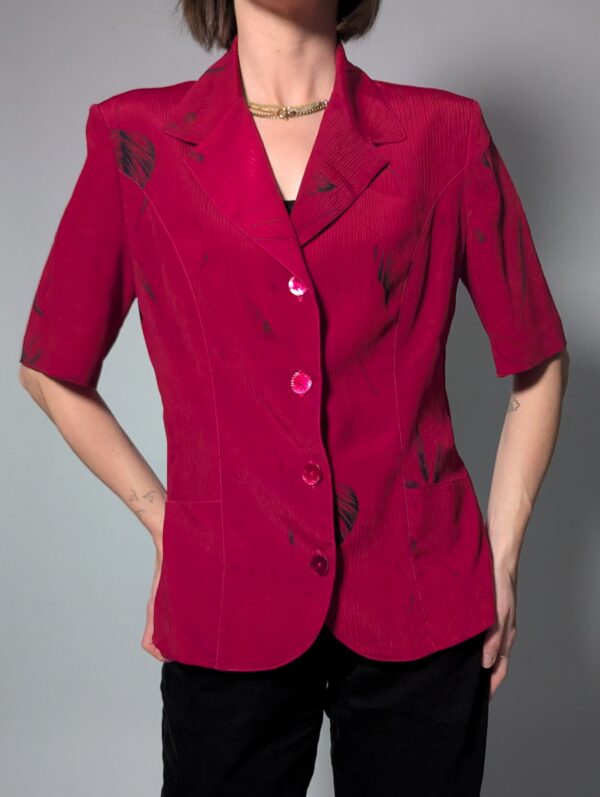 Vintage berryroze blouse-blazer met korte mouwen, glanzende knopen, subtiele bladprint en getailleerde pasvorm.