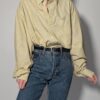 Lichtgele vintage blouse met fijne verticale streep, lange mouwen, oversized fit en borstzak.