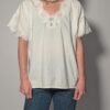 Witte vintage blouse met korte mouwen, broderie details en sierlijke V-hals.