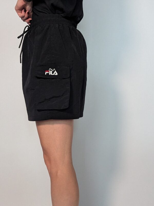 Vintage zwart Fila rokje met elastische taille, strikkoord en cargo zakdetails aan de zijkant.
