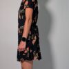 Vintage donkerblauwe jurk met korte pofmouwen, knoopsluiting en rozenprint in rood- en groentinten.