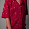 Scarlet stitch 04 Vintage rode blouse met korte mouwen, klassieke kraag en subtiel goudkleurig bloem- en rankborduurwerk.